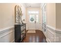 Inviting entryway features hardwood floors, a decorative mirror, and a front door with glass panels at 5130 Watersail Way, Clover, SC 29710