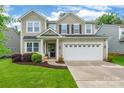 Charming two-story home featuring a well-maintained lawn and a two-car garage at 5130 Watersail Way, Clover, SC 29710