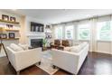 Bright living room with a fireplace, floating shelves, and comfortable seating at 5130 Watersail Way, Clover, SC 29710