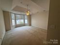 Large bedroom features plush carpet, bay window, and ceiling fan at 5476 Ives Nw St, Concord, NC 28027