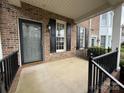 Charming front porch with brick facade, black shutters and railing at 5476 Ives Nw St, Concord, NC 28027