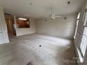 Spacious living room features carpet flooring, ceiling fan, and bright natural light at 5476 Ives Nw St, Concord, NC 28027