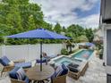 Inviting backyard patio area with plush seating around a fire pit and a sparkling pool at 628 Bracket St, Fort Mill, SC 29708