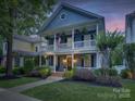 Charming two-story home with a welcoming porch and lush landscaping, perfect for enjoying the outdoors at 628 Bracket St, Fort Mill, SC 29708