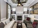 Stylish living room with a stone fireplace, built-in bookshelves, and plenty of natural light at 6510 Honeymeade Cir, Charlotte, NC 28277