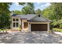 Charming painted-brick home featuring a two-car garage, and a welcoming front porch at 6639 Camp Creek Rd, Lancaster, SC 29720