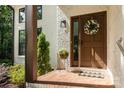 Close-up of a welcoming front door with decorative wreath and brick landing at 6639 Camp Creek Rd, Lancaster, SC 29720