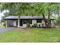 Charming single-story home featuring a carport, painted brick, and manicured lawn at 818 Stowe Ln, Gastonia, NC 28056
