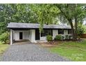 Charming single-story home featuring a carport, painted brick, and manicured lawn at 818 Stowe Ln, Gastonia, NC 28056