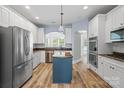 Spacious kitchen with white cabinets, stainless steel appliances, granite counters, and a center island at 1009 Jerry Ln, Matthews, NC 28105