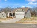 Attractive home with stone accents, neutral siding and an attached two-car garage at 1074 Bull Dog Ln, Wingate, NC 28174