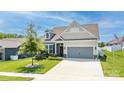 Beautiful home featuring a well-maintained lawn, attractive landscaping, and a gray two-car garage at 128 Asher Ln, Mooresville, NC 28115