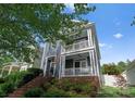 Charming two-story home with inviting double porches and manicured landscaping at 14034 Holly Springs Dr, Huntersville, NC 28078