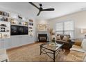 Cozy living room featuring a fireplace, custom built-ins, and stylish decor at 14034 Holly Springs Dr, Huntersville, NC 28078