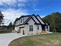 Well-manicured lawn surrounds the home with an attached garage and modern design at 1427 Kinks Ln # 47, Maiden, NC 28650