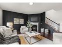 Stylish living room with a fireplace, dark accent wall, and comfortable seating and decor at 14407 Cardwell Hill Ln, Charlotte, NC 28278