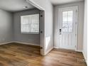 Bright entryway with wood-look flooring and natural light, leading to other rooms at 1441 Mccollum St, Monroe, NC 28112