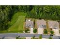 Aerial shot of two homes with wooded backyards, neatly maintained lawns, and driveways that line up to the street at 1467 Tranquility Blvd, Lancaster, SC 29720
