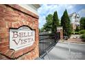 Belle Vista entrance with brick wall, manicured landscaping and stately condos in background at 14979 Santa Lucia Dr # 2408, Charlotte, NC 28277