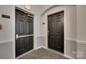 Hallway showing the door to unit 14179 and the exit to the stairs at 14979 Santa Lucia Dr # 2408, Charlotte, NC 28277