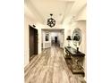 Beautifully decorated hallway with elegant console table, wood-style flooring, and modern lighting at 14979 Santa Lucia Dr # 2408, Charlotte, NC 28277