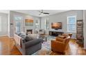 Cozy living room features a fireplace, hardwood floors, neutral paint and plenty of natural light at 15830 Waterfront Dr, Huntersville, NC 28078
