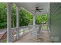 Inviting porch with rocking chairs and ceiling fan, perfect for relaxing and enjoying the outdoors at 15830 Waterfront Dr, Huntersville, NC 28078