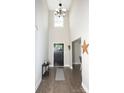 Inviting foyer with soaring ceilings, dark wood floors, and stylish black front door and decor at 164 Vance Farm Dr, Statesville, NC 28625