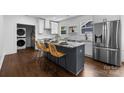 Modern kitchen with white cabinets, stainless steel appliances, marble countertops, and a center island at 1922 Thomas Ave, Charlotte, NC 28205
