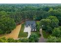 Expansive aerial view of a luxurious home surrounded by lush greenery and mature trees, ensuring privacy at 20000 Schooner Dr, Cornelius, NC 28031