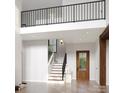 Bright entryway with hardwood floors, staircase, and a view of the upper level at 20000 Schooner Dr, Cornelius, NC 28031