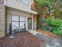 Inviting front entrance with a decorative wreath on the door and a charming bench with plants at 2324 Brookview Ct, Rock Hill, SC 29732