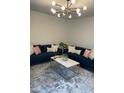 Stylish living room featuring plush blue sofas, a modern light fixture, and a chic marble coffee table at 2324 Brookview Ct, Rock Hill, SC 29732