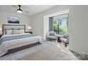 Sunlit main bedroom with a large window, comfortable seating area, and a beautifully styled bed at 2324 Brookview Ct, Rock Hill, SC 29732