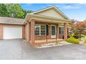 Inviting brick home with a cozy front porch and attached garage at 2561 26Th Ne Ave, Hickory, NC 28601