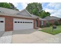 Charming brick home featuring a two-car garage and a well-manicured lawn at 3814 Misty Glen Ct, Matthews, NC 28105