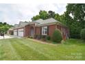 Charming brick home featuring a two-car garage and a well-manicured lawn at 3814 Misty Glen Ct, Matthews, NC 28105