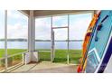 Screened-in porch offers a view of the lake, boats, paddleboards, and outdoor recreation at 401 Lake Club Dr, Rock Hill, SC 29732