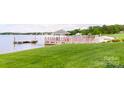 Lakeside gazebo on lush lawn with dock offering access to water activities and scenic relaxation at 401 Lake Club Dr, Rock Hill, SC 29732