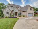 Beautiful elevation of a home with brick and stone accents, complemented by a meticulously maintained lawn at 4025 Foxes Trl, Cramerton, NC 28032