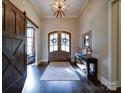 Grand foyer boasting a unique light fixture, hardwood floors, and a stylish console table at 4025 Foxes Trl, Cramerton, NC 28032