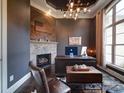 Charming office featuring a stone fireplace, custom desk, and sophisticated decor at 4025 Foxes Trl, Cramerton, NC 28032