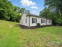 White brick home with black shutters and lush, green lawn at 419 Wade St, Wadesboro, NC 28170