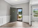 Inviting entryway with grey walls, white trim, and a view of the outdoors through the screen door at 4576 Fox Ridge Ln, Fort Mill, SC 29707