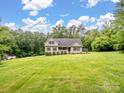 A long view of a charming two-story home on large well-manicured lawn at 5369 Concord Rd, York, SC 29745