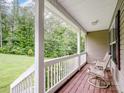 Relaxing covered porch with wood flooring and serene views of the surrounding greenery at 5369 Concord Rd, York, SC 29745