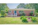 Brick home boasts a tidy front yard and manicured garden beds at 616 26Th Nw St, Hickory, NC 28601