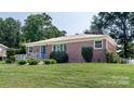 Well-kept brick home featuring lush green lawn and neatly trimmed shrubs at 616 26Th Nw St, Hickory, NC 28601
