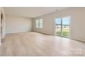 Bright living room with wood floor and sliding glass door leading to the backyard at 6301 Fairfax Ct, Maiden, NC 28650