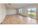 Bright living room with gleaming hardwood floors, large windows, and a sliding glass door at 6337 Fairfax Ct, Maiden, NC 28650